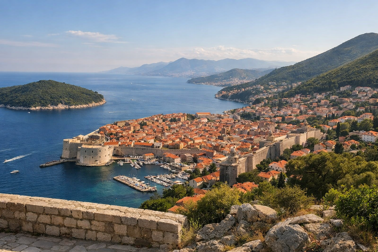 Historic coastal city with green hills and distant mountains